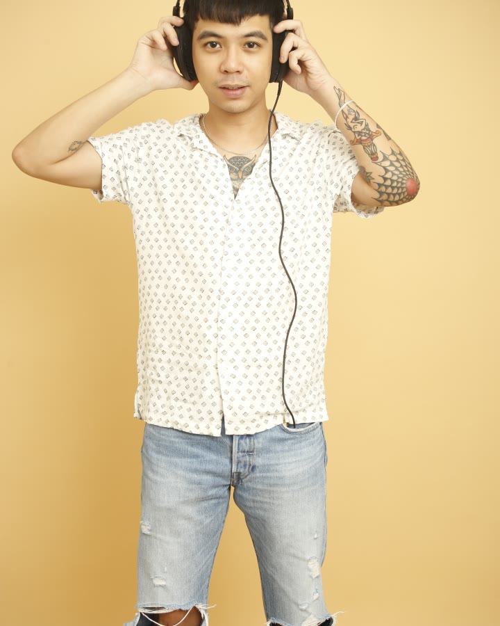 Studio portrait of REIDEL wearing headphones.